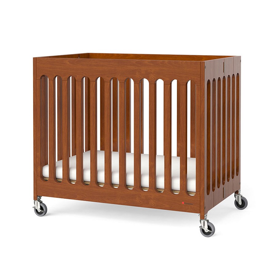 Foundations Compact Boutique Wood Folding Crib Slatted With Oversized Casters & 3' Foam Mattress Cherry 